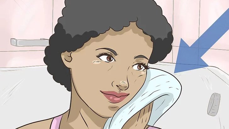 A Lady With Short Curly Hair Wipes Her Face With A Towel